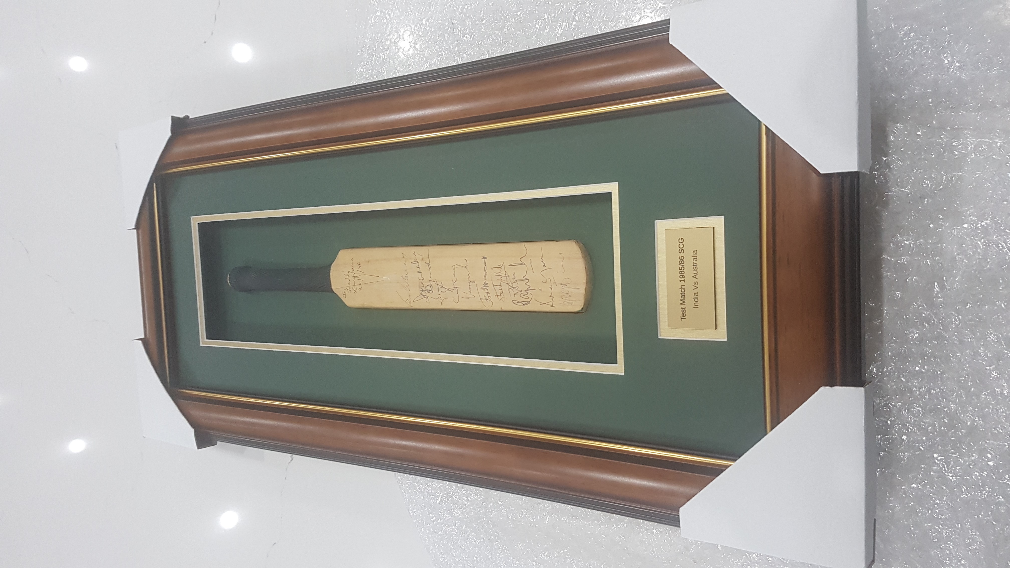 Miniature signed cricket bat framed in a traditional timber shadow box